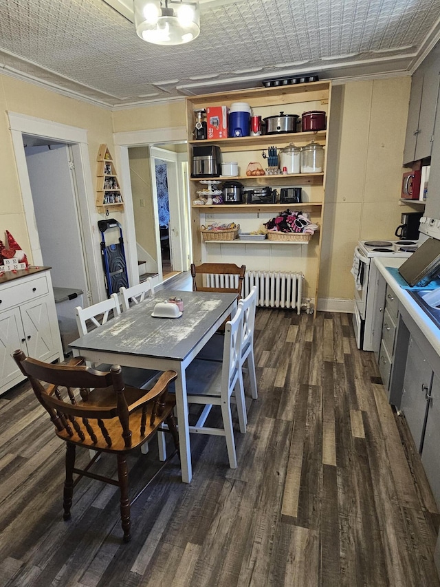 dining area with radiator, dark hardwood / wood-style flooring, and crown molding