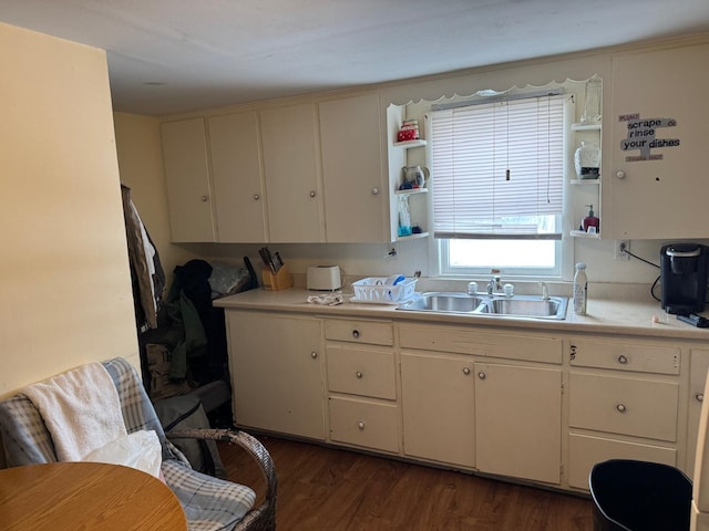 10 Russ St, Caribou, ME 04736 - kitchen with light countertops, a sink, open shelves, and dark wood finished floors