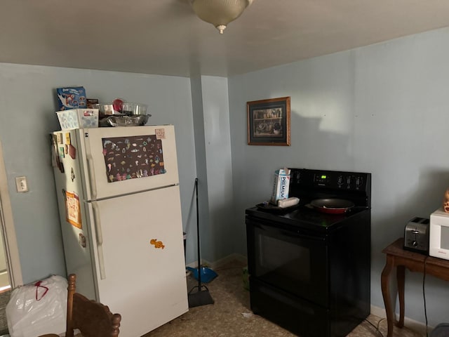 10 Russ St, Caribou, ME 04736 - kitchen featuring baseboards, black electric range oven, and freestanding refrigerator