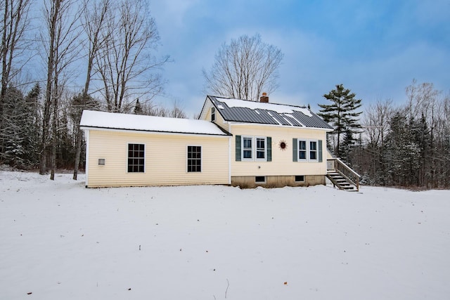 view of snow covered rear of property