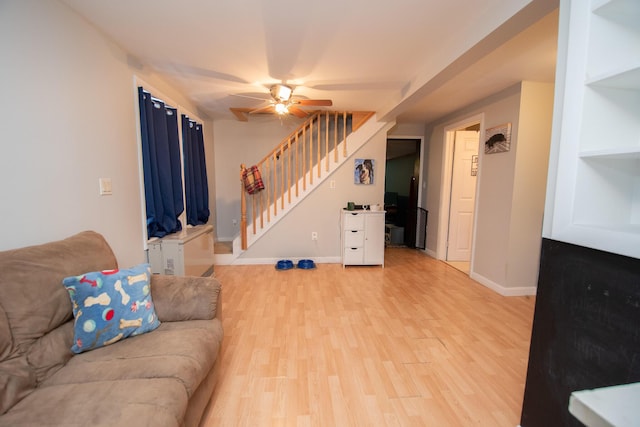 living room featuring ceiling fan and light wood-type flooring