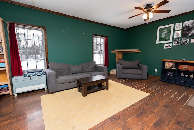 living room with crown molding, ceiling fan, and dark wood-type flooring