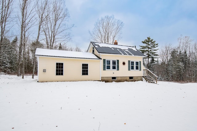 view of snow covered rear of property