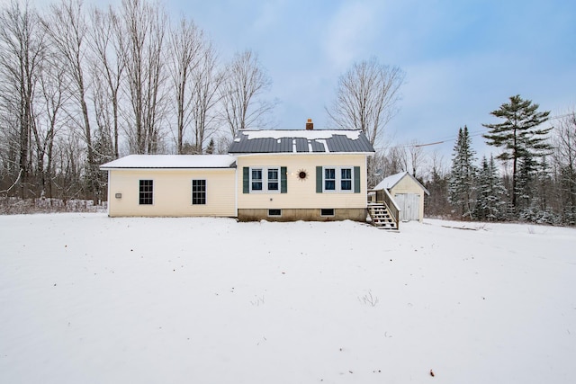 view of snow covered back of property