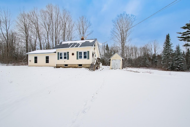 view of front of house with a storage shed