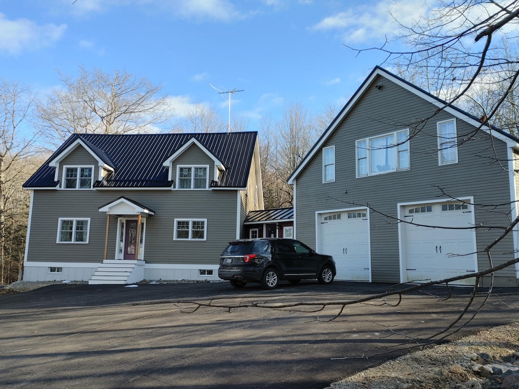 704 Lincolnville Ave, Searsmont, ME 04973 - view of front of house with metal roof and an attached garage