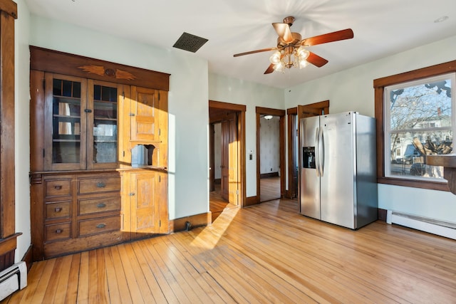 kitchen featuring ceiling fan, light wood-type flooring, stainless steel fridge with ice dispenser, and a baseboard radiator