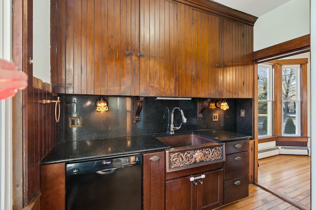 kitchen with light wood-type flooring, tasteful backsplash, dark stone counters, sink, and dishwasher