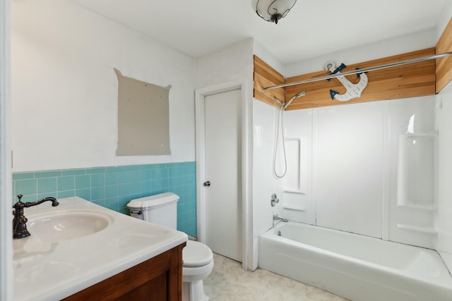 full bathroom featuring shower / bathing tub combination, vanity, tile walls, and toilet