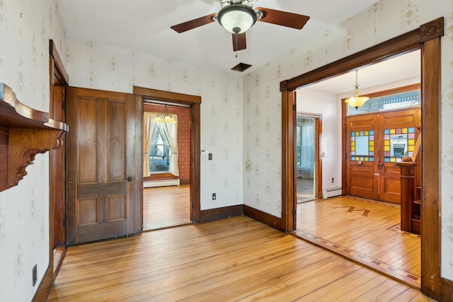 entrance foyer with french doors, light wood-type flooring, a baseboard radiator, and ceiling fan