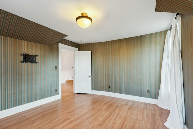 unfurnished room with hardwood / wood-style floors