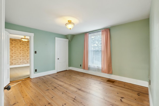 empty room featuring hardwood / wood-style flooring