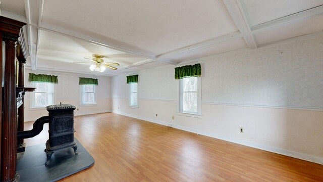 unfurnished living room with hardwood / wood-style flooring, beam ceiling, ceiling fan, and coffered ceiling