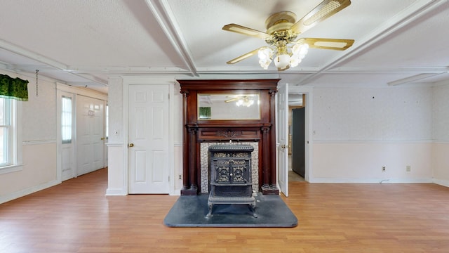 unfurnished living room featuring light wood-type flooring, ceiling fan, and a textured ceiling