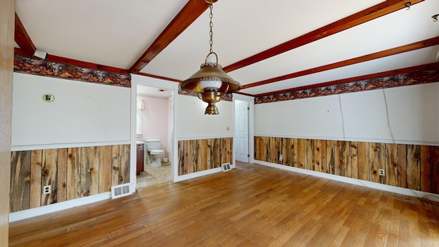 interior space with hardwood / wood-style flooring and beamed ceiling