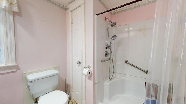 bathroom with toilet and walk in shower