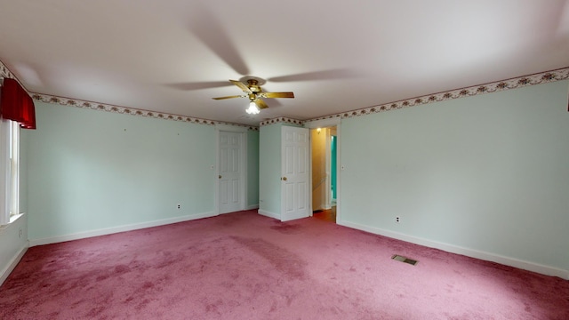 carpeted spare room with ceiling fan