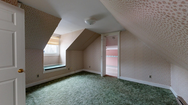 bonus room featuring vaulted ceiling and carpet flooring