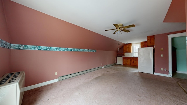 additional living space with vaulted ceiling, baseboard heating, ceiling fan, and light carpet