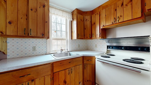 kitchen with sink, backsplash, and white electric stove