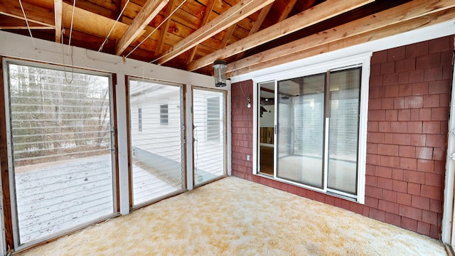 unfurnished sunroom with beam ceiling and wooden ceiling