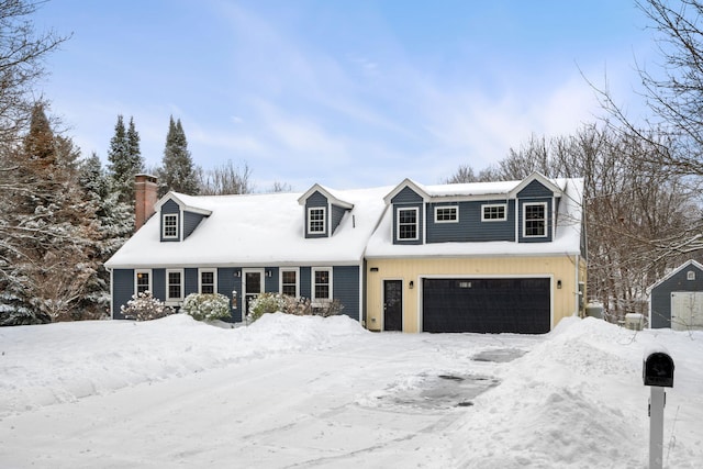 cape cod house featuring a garage