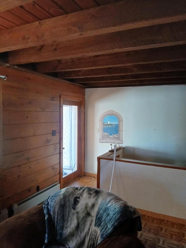 bedroom featuring beamed ceiling, baseboard heating, and wood ceiling