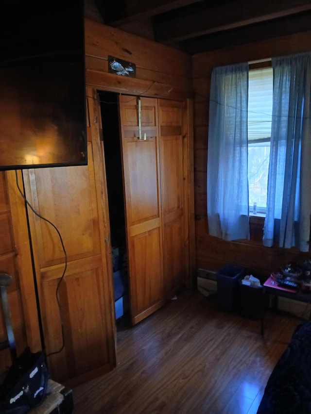 interior space featuring dark hardwood / wood-style flooring and wood walls