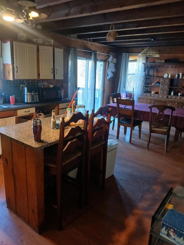 kitchen with a kitchen island and wood-type flooring