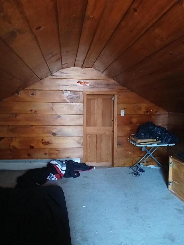 additional living space with carpet flooring, wooden ceiling, and wood walls