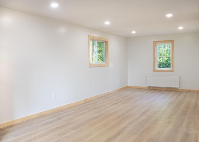 284 Flanders Pond Rd, Sullivan, ME 04664 - spare room with radiator heating unit, recessed lighting, light wood-type flooring, and healthy amount of natural light