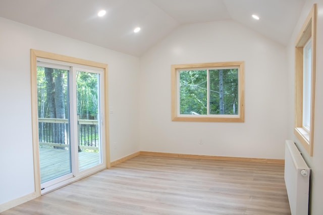 284 Flanders Pond Rd, Sullivan, ME 04664 - spare room with radiator, light wood-style floors, lofted ceiling, and recessed lighting