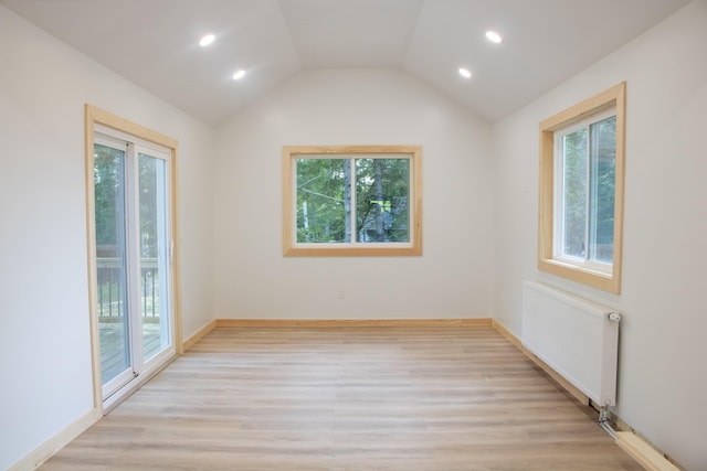 284 Flanders Pond Rd, Sullivan, ME 04664 - spare room with radiator heating unit, plenty of natural light, recessed lighting, and vaulted ceiling