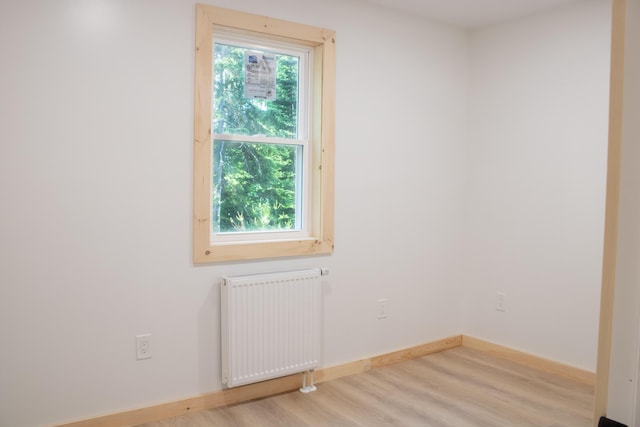 284 Flanders Pond Rd, Sullivan, ME 04664 - unfurnished room with radiator and wood finished floors