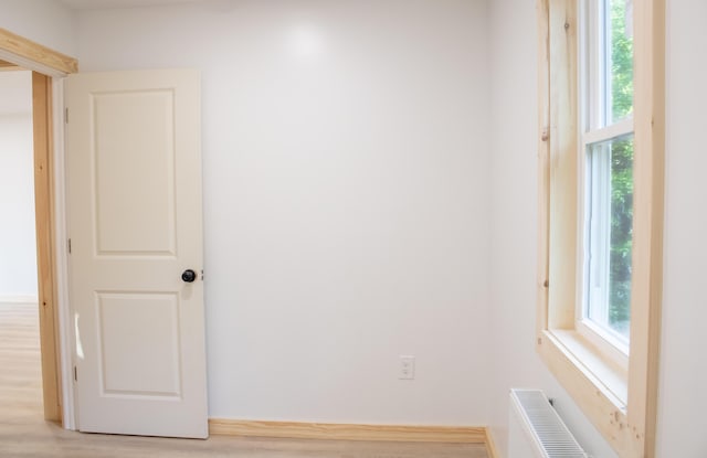 284 Flanders Pond Rd, Sullivan, ME 04664 - empty room featuring light wood-style flooring and radiator heating unit