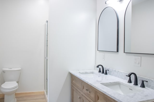 284 Flanders Pond Rd, Sullivan, ME 04664 - bathroom featuring double vanity, wood finished floors, and an enclosed shower
