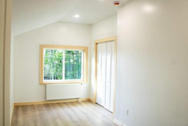 284 Flanders Pond Rd, Sullivan, ME 04664 - empty room featuring radiator, wood finished floors, a smoke detector, lofted ceiling, and recessed lighting