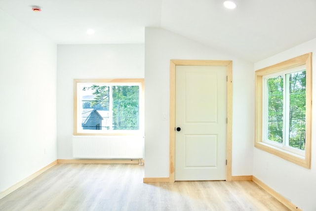 284 Flanders Pond Rd, Sullivan, ME 04664 - spare room featuring radiator, light wood-style floors, a smoke detector, vaulted ceiling, and recessed lighting