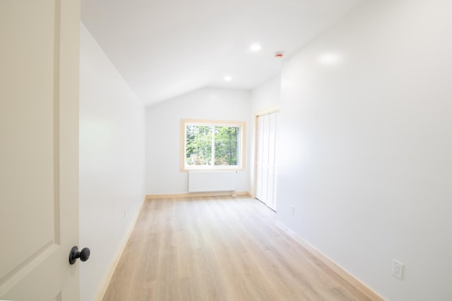 284 Flanders Pond Rd, Sullivan, ME 04664 - empty room featuring radiator heating unit, light wood-style floors, lofted ceiling, and recessed lighting