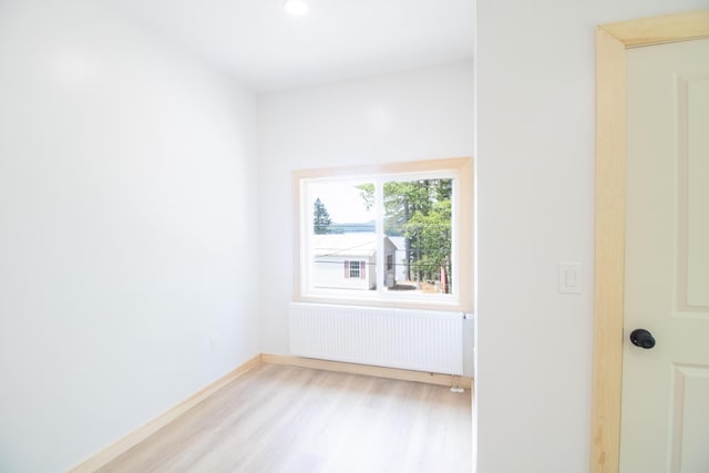 284 Flanders Pond Rd, Sullivan, ME 04664 - empty room with radiator, light wood finished floors, and recessed lighting