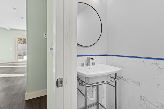 bathroom featuring tile walls and wood-type flooring