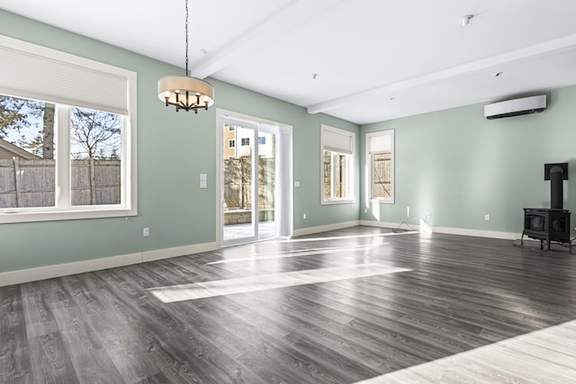 unfurnished living room featuring a wall unit AC, a notable chandelier, dark hardwood / wood-style floors, a wood stove, and beam ceiling