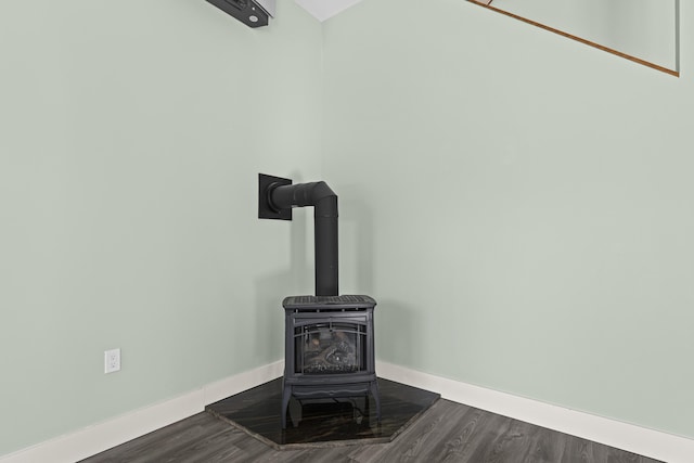 details featuring hardwood / wood-style flooring and a wood stove