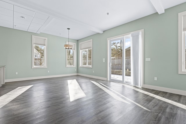 interior space with a healthy amount of sunlight, dark hardwood / wood-style flooring, and beamed ceiling