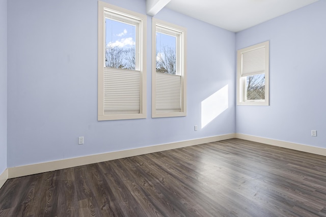 spare room with dark hardwood / wood-style floors