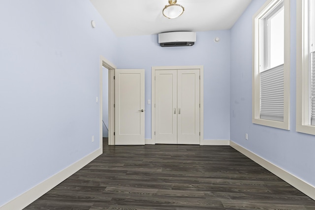 entryway with an AC wall unit and dark hardwood / wood-style floors