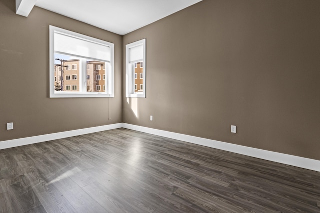 unfurnished room featuring dark wood-type flooring