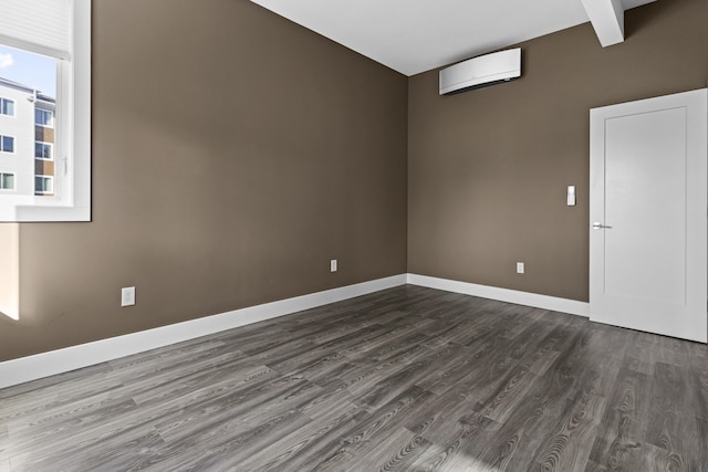 empty room with a wall mounted air conditioner and dark hardwood / wood-style floors