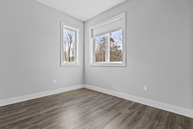 spare room with dark hardwood / wood-style flooring