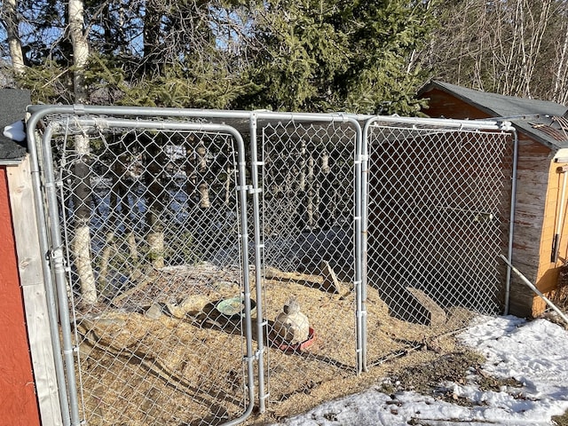 view of gate with an outbuilding